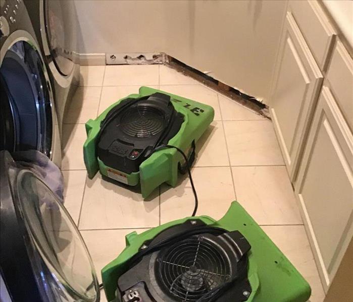 Drying equipment in laundry room.