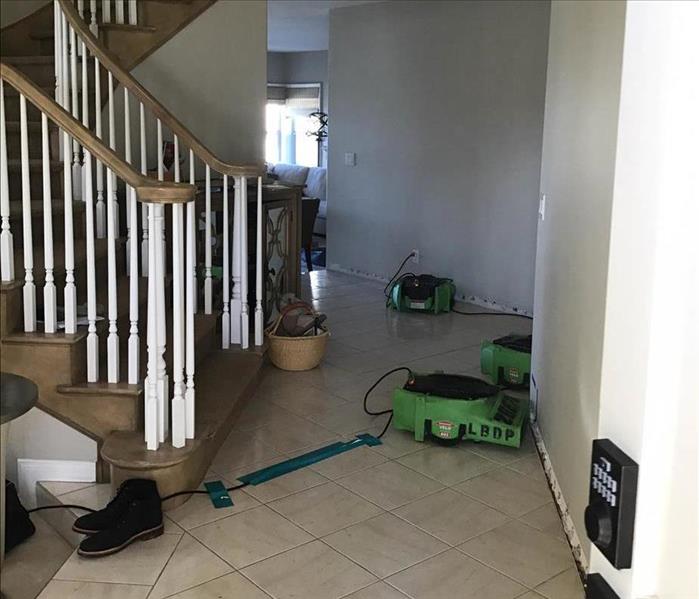 Drying equipment drying out floors on the first story of a Costa Mesa home.