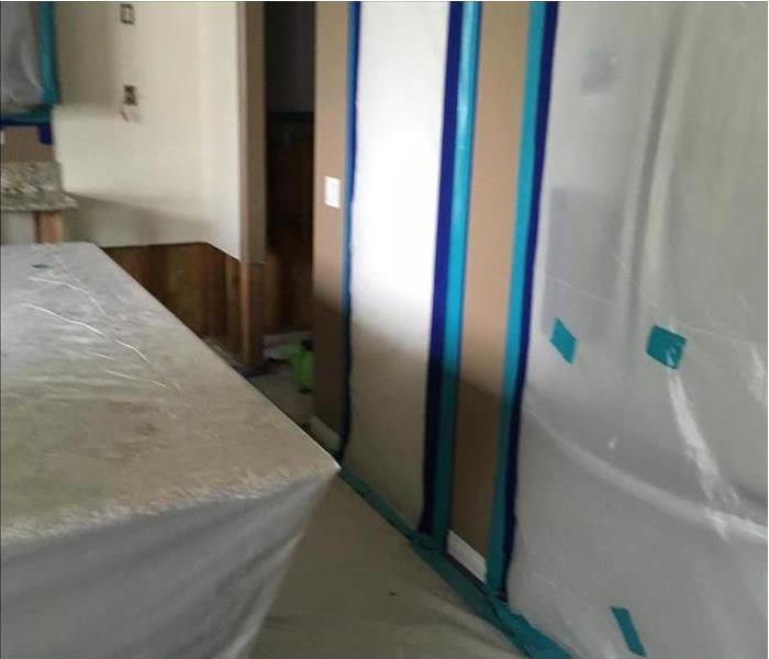Containment barriers set up for mold removal in a room